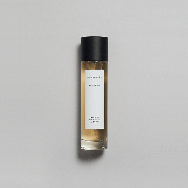 Munlark Ash Parfum by Mihan Aromatics, featuring a minimalist bottle with a simple label and a cool, earthy fragrance.