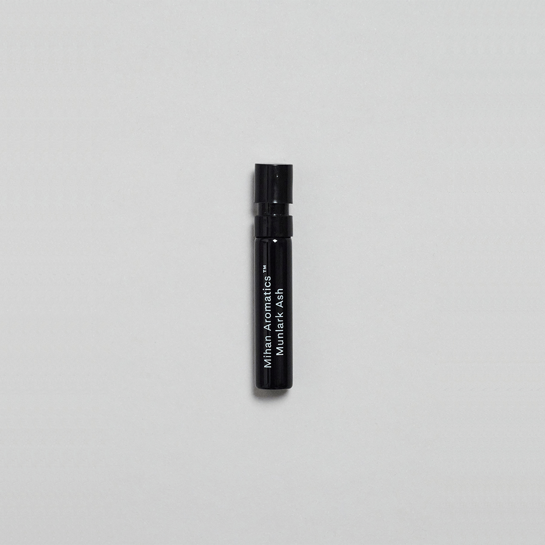 Munlark Ash Parfum by Mihan Aromatics in a sleek black spray vial against a plain backdrop.