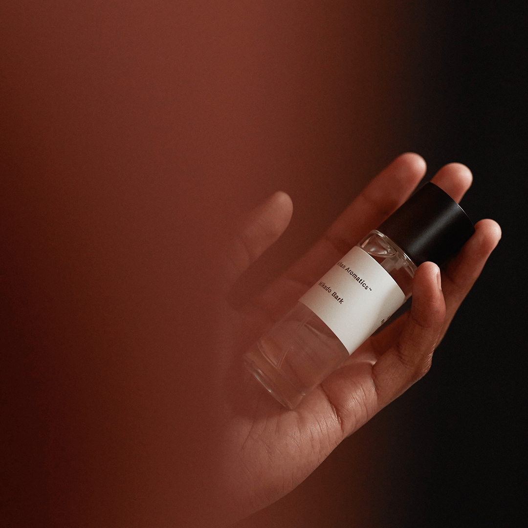 Mikado Bark Parfum bottle held in a hand, evoking tranquil autumn vibes and crisp air.