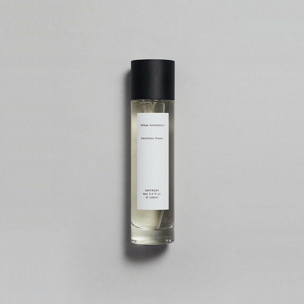 Petrichor Plains Parfum by Mihan Aromatics in a sleek bottle, evoking the essence of rain on dry earth.