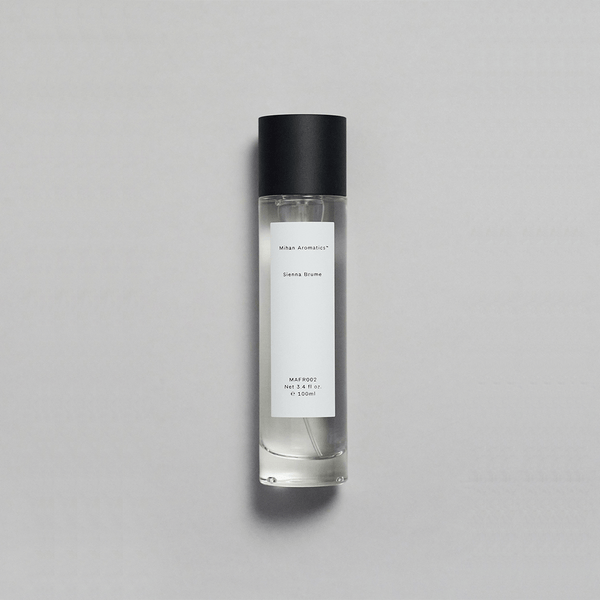 Sienna Brume Parfum bottle featuring a minimalist design with a black cap and crisp fragrance.