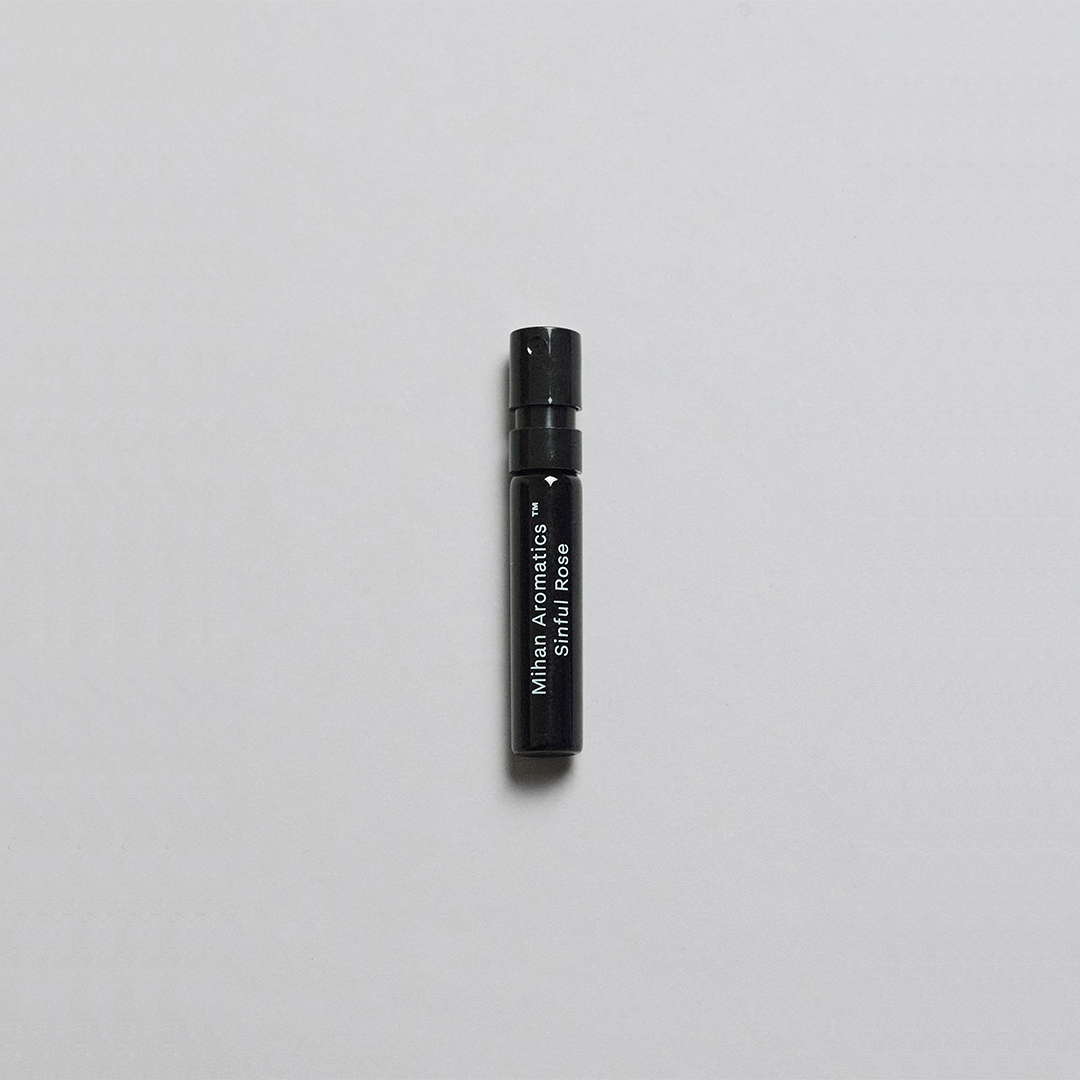 Sinful Rose Parfum by Mihan Aromatics in a sleek black spray vial on a white background.