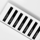Discovery Set featuring 7 black vials of signature fragrances in a sleek white box.