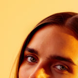 Close portrait in golden light behind soft wattle blossom, Mihan Aromatics Series Three campaign