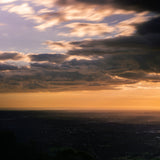 Sunset breaking beneath the clouds over a valley in the Victorian bush, Mihan Aromatics Series Three campaign