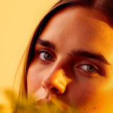 Close portrait in golden light behind soft wattle blossom, Mihan Aromatics Eucalyptus Bloom parfum campaign