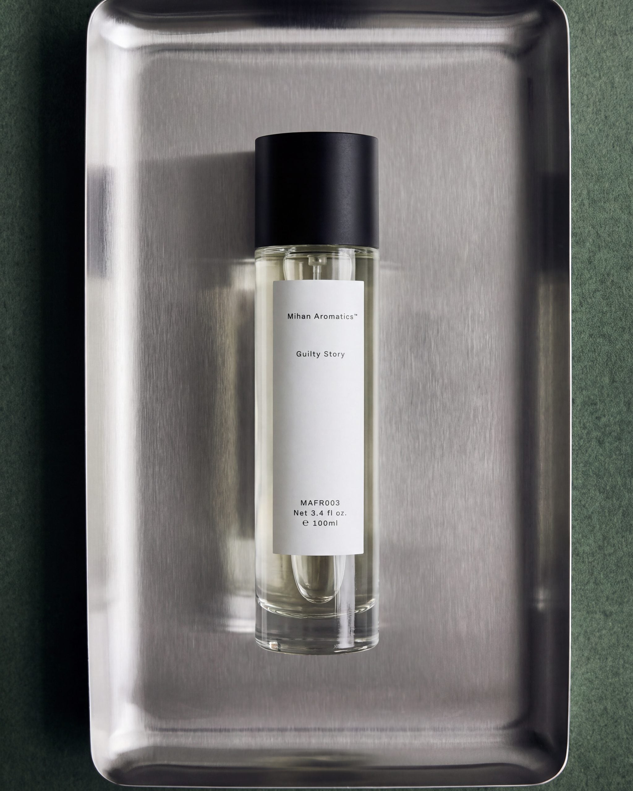 Mihan Aromatics Guilty Story parfum 100ml bottle on a steel tray