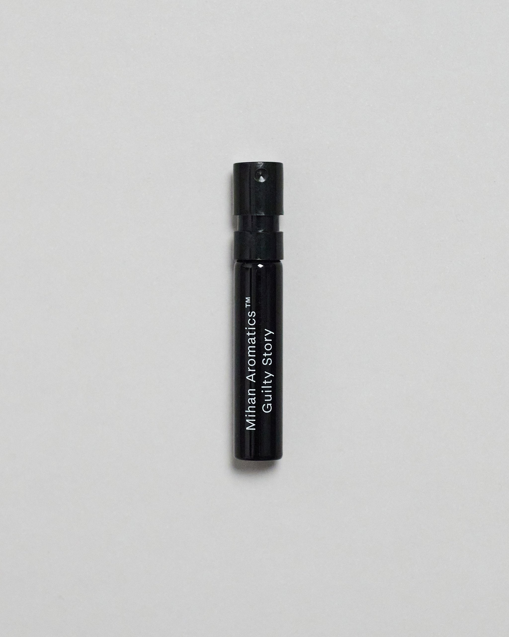 Mihan Aromatics Guilty Story parfum 2ml sample vial on a pale grey backdrop