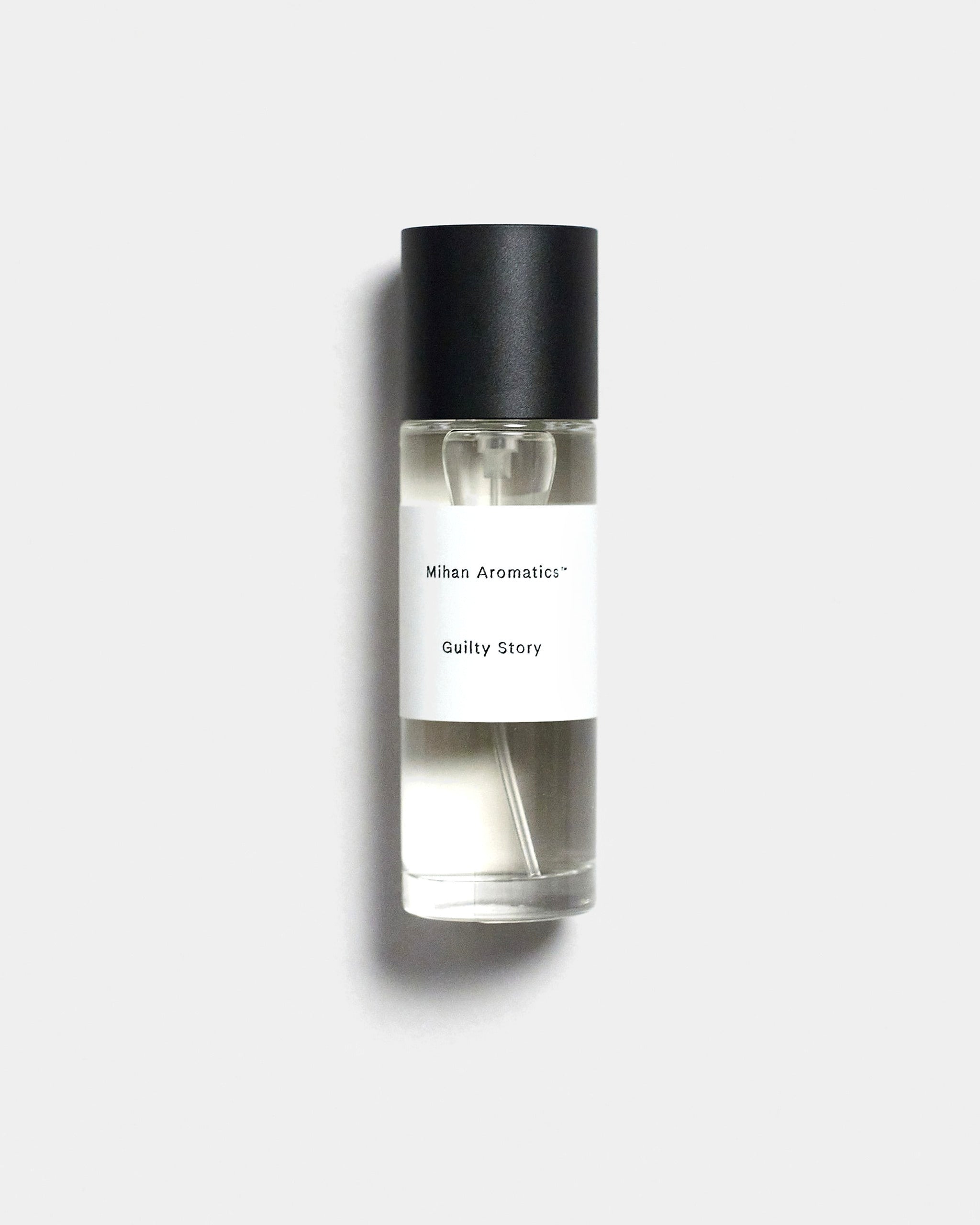 Mihan Aromatics Guilty Story parfum 30ml bottle with black cap on a Studio Grey backdrop