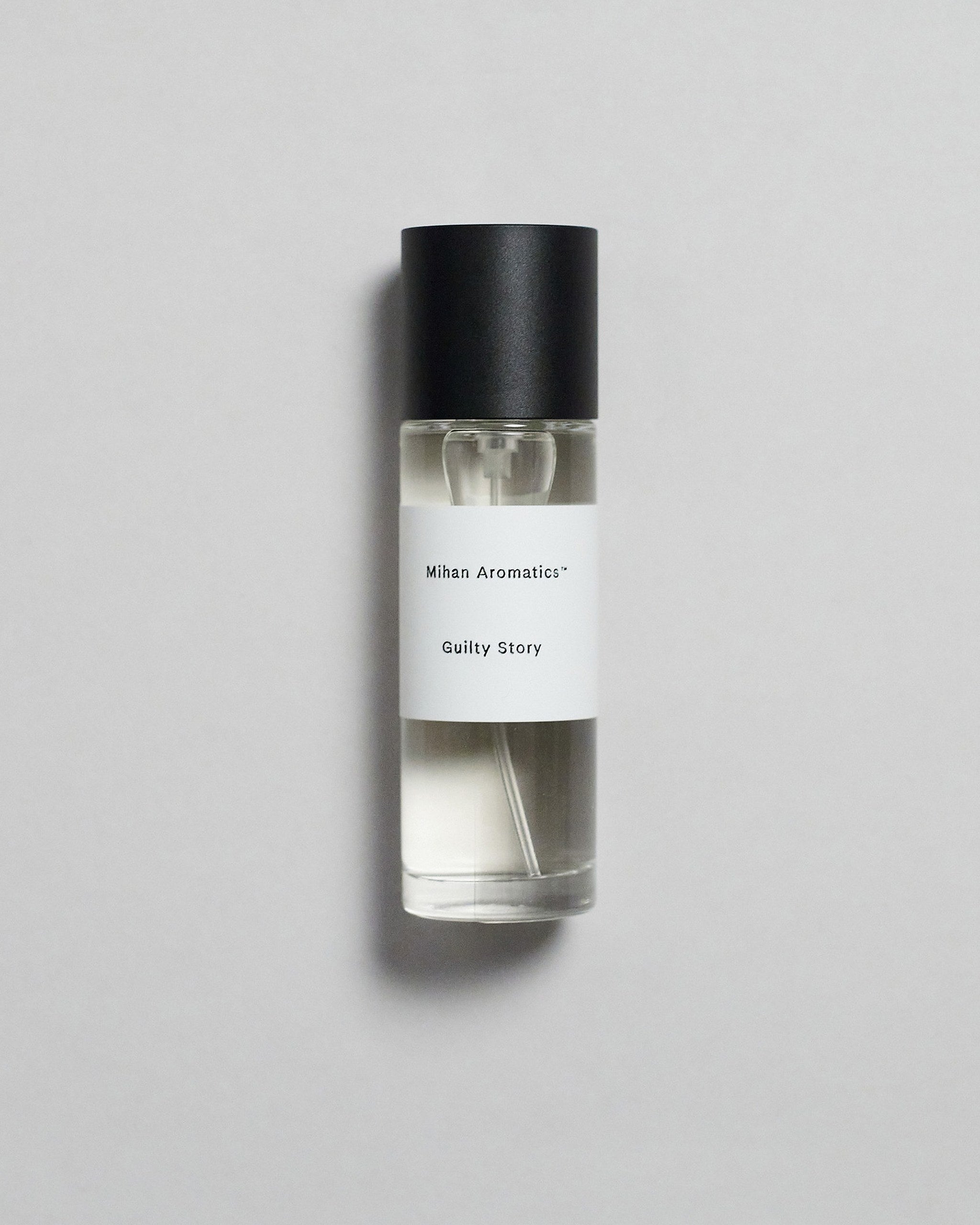 Mihan Aromatics Guilty Story parfum 30ml bottle with black cap on a pale grey backdrop