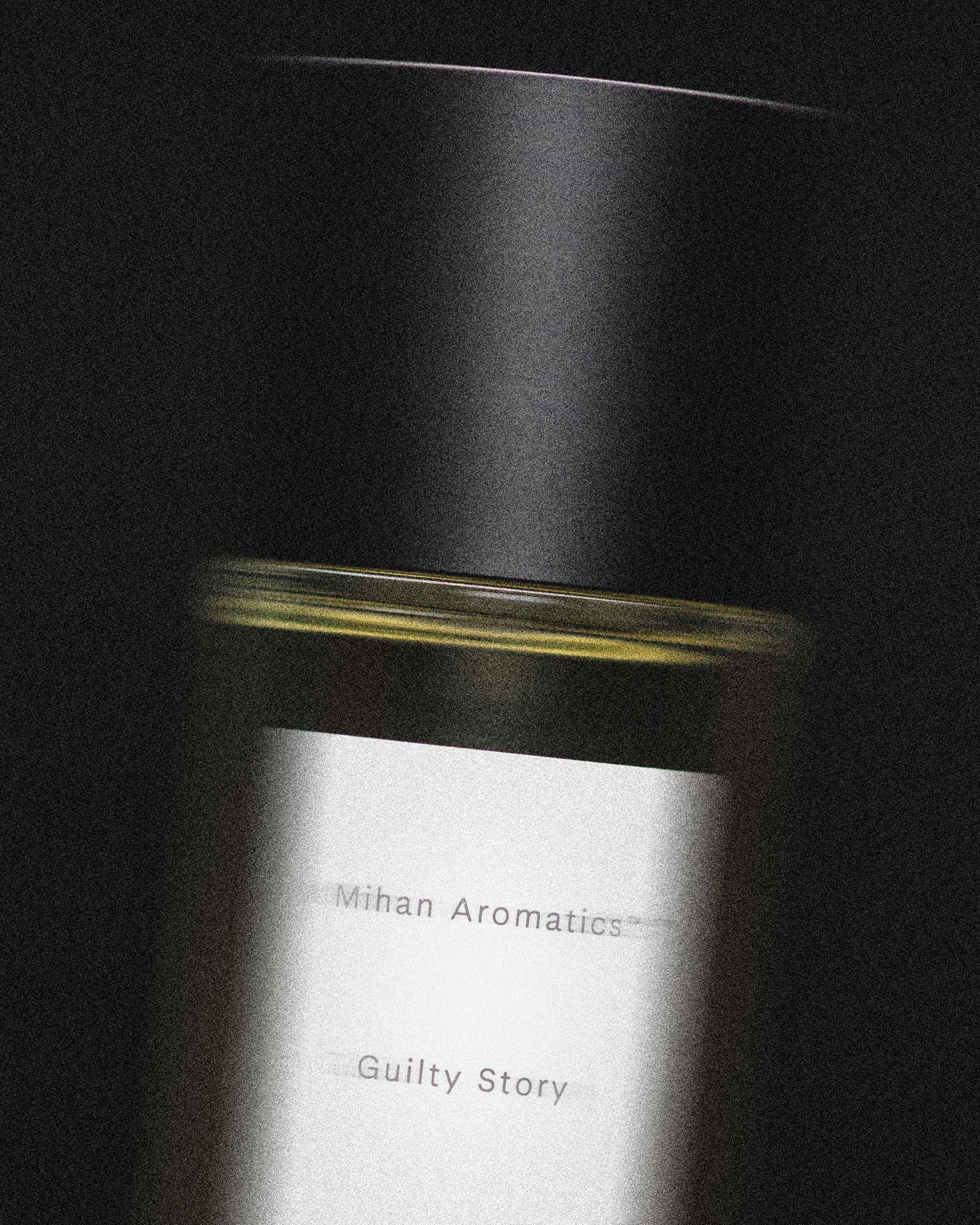 Close view of the Mihan Aromatics Guilty Story parfum bottle and label in low light