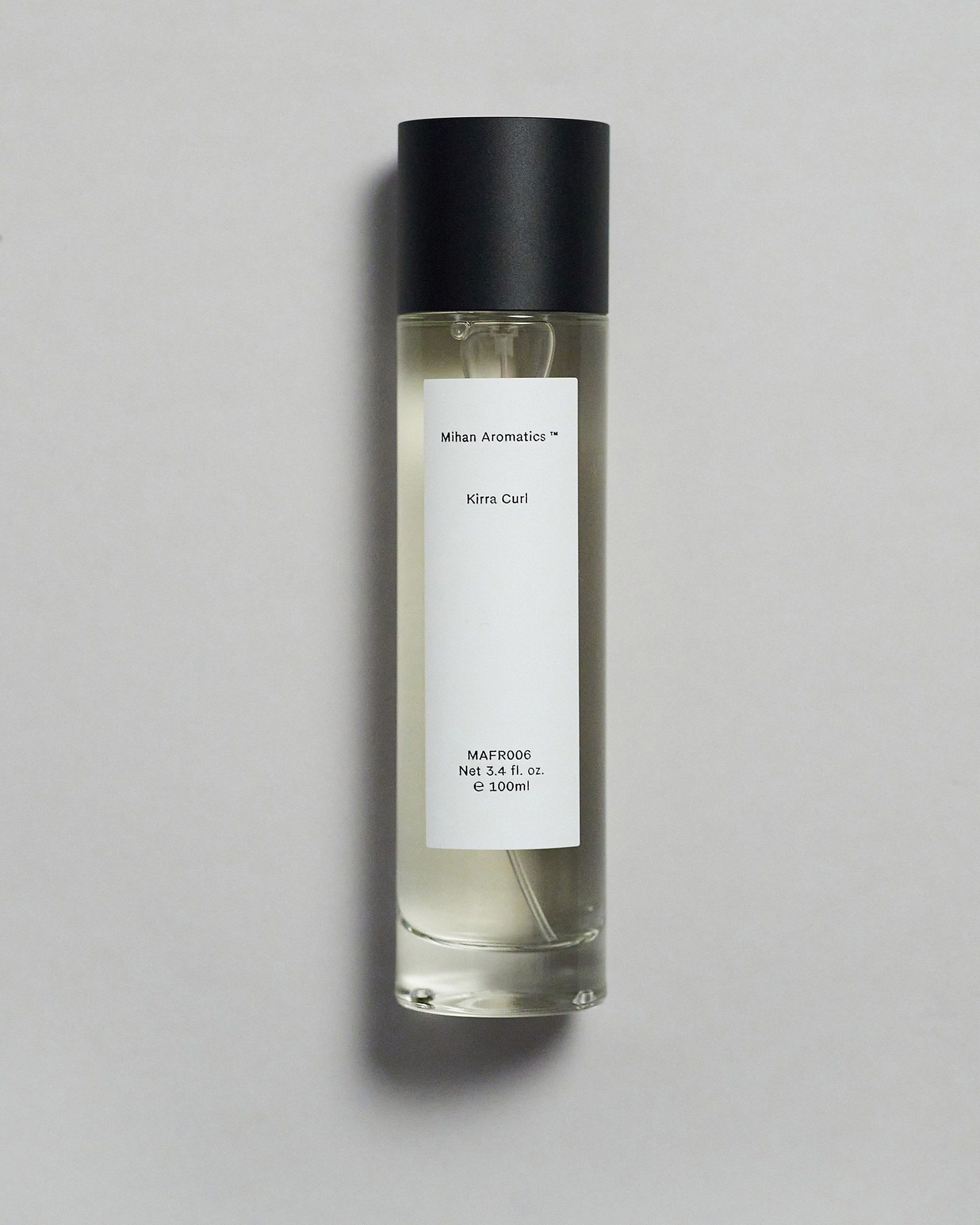 Mihan Aromatics Kirra Curl parfum 100ml bottle with black cap on a pale grey backdrop