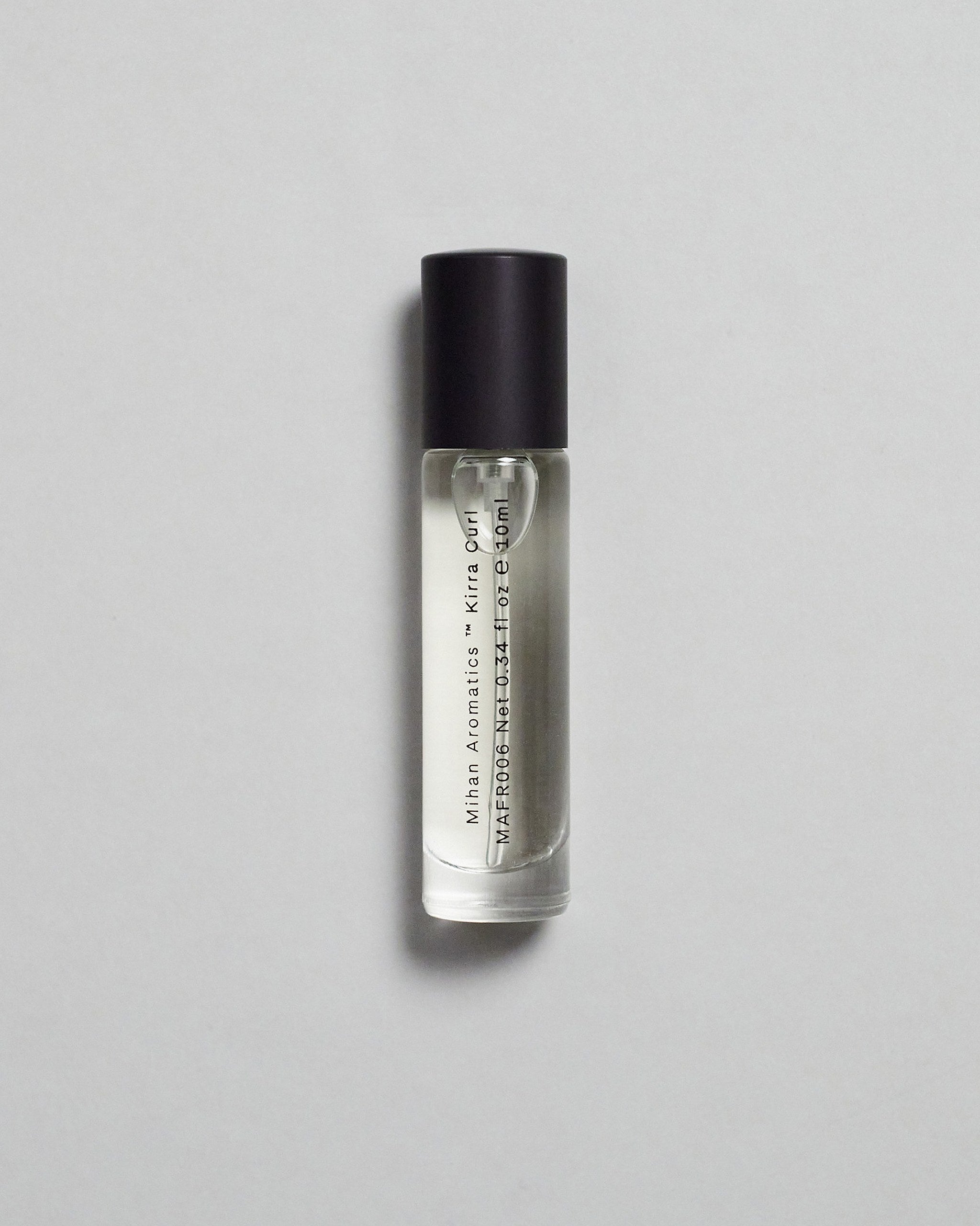 Mihan Aromatics Kirra Curl parfum 10ml bottle with black cap on a pale grey backdrop