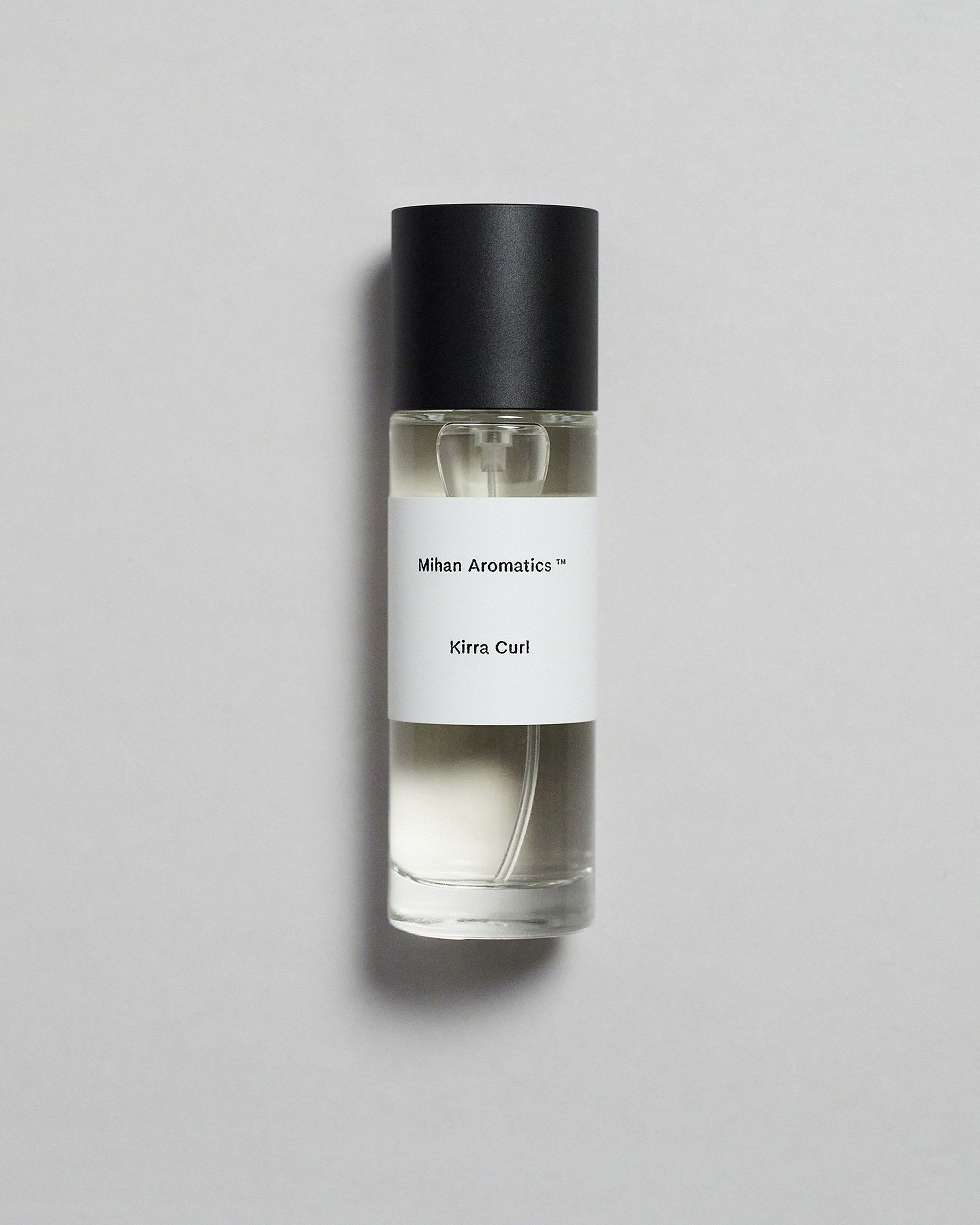 Mihan Aromatics Kirra Curl parfum 30ml bottle with black cap on a pale grey backdrop