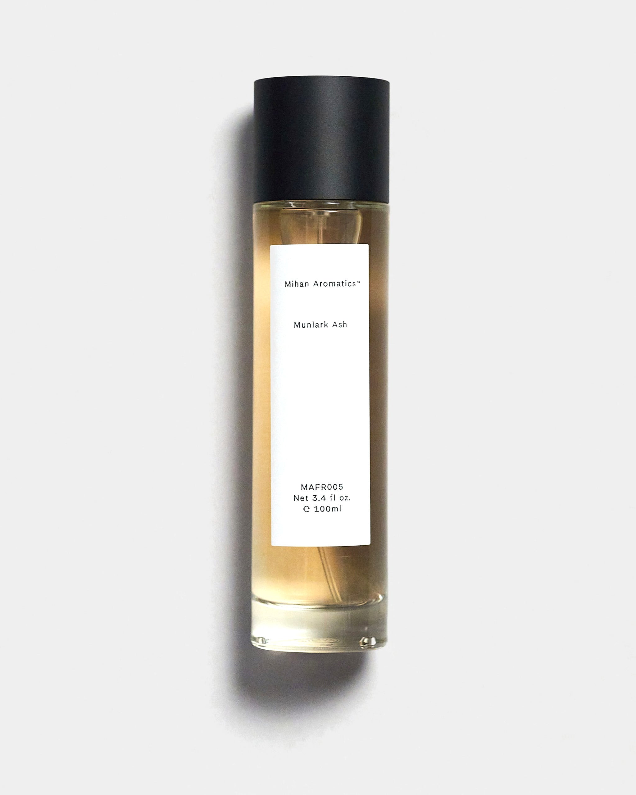 Mihan Aromatics Munlark Ash parfum 100ml bottle with black cap on a Studio Grey backdrop