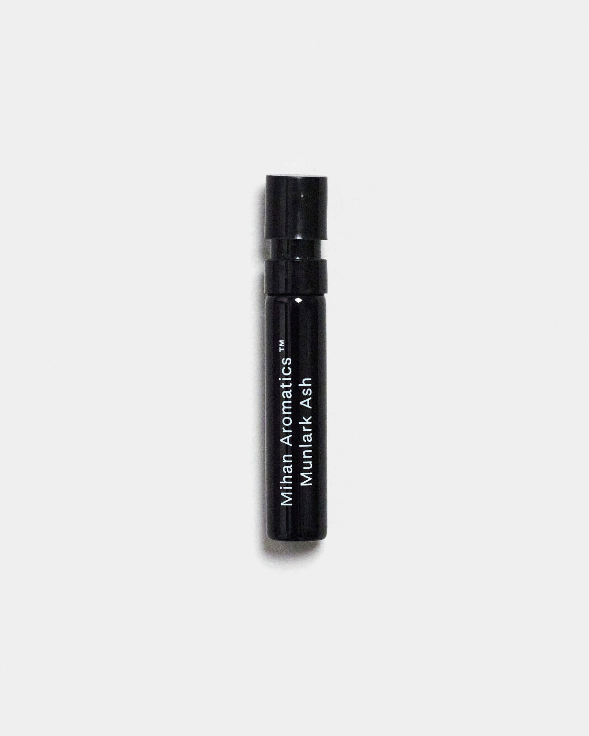 Mihan Aromatics Munlark Ash parfum 2ml sample vial on a Studio Grey backdrop