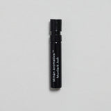 Mihan Aromatics Munlark Ash parfum 2ml sample vial on a pale grey backdrop