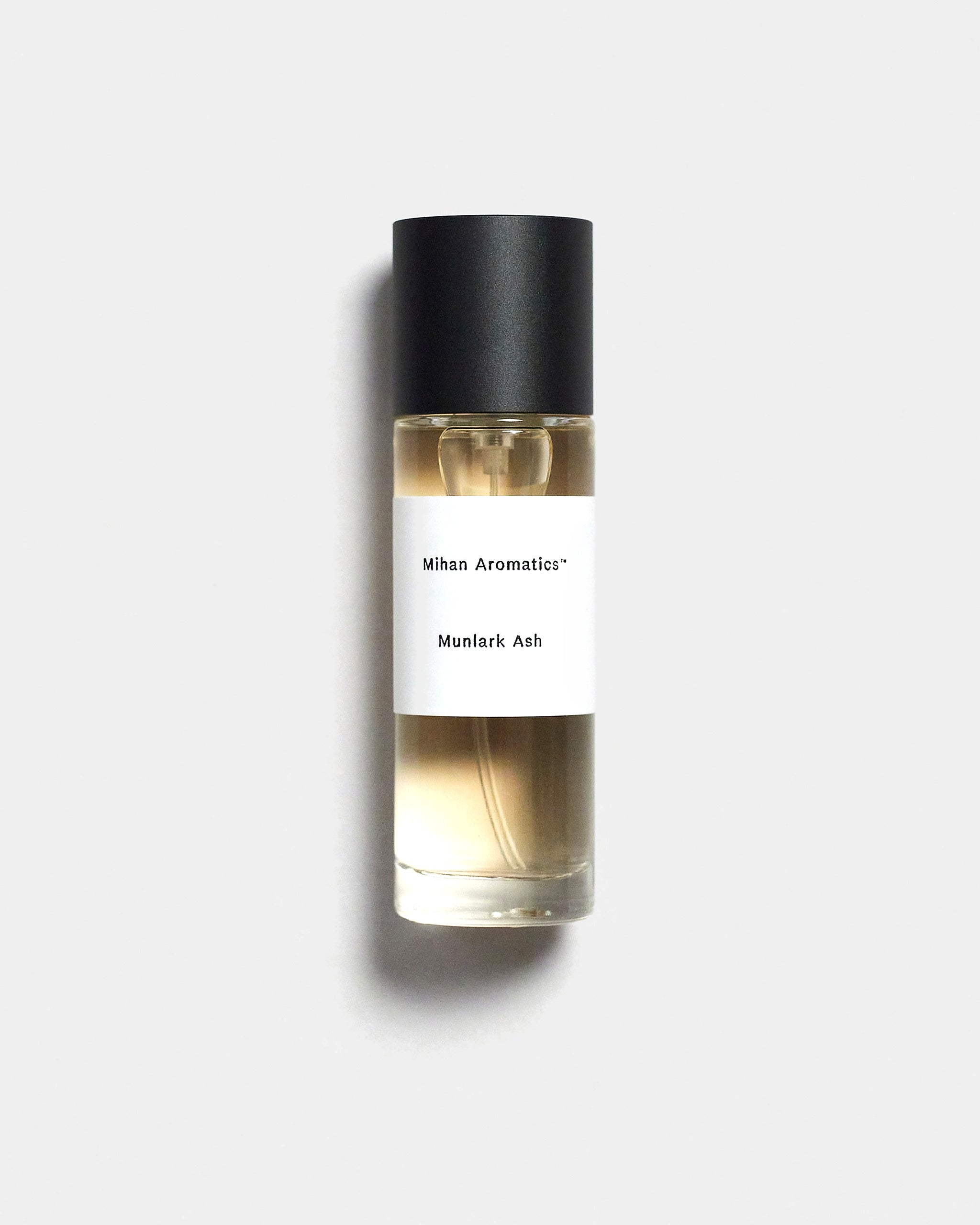 Mihan Aromatics Munlark Ash parfum 30ml bottle with black cap on a Studio Grey backdrop