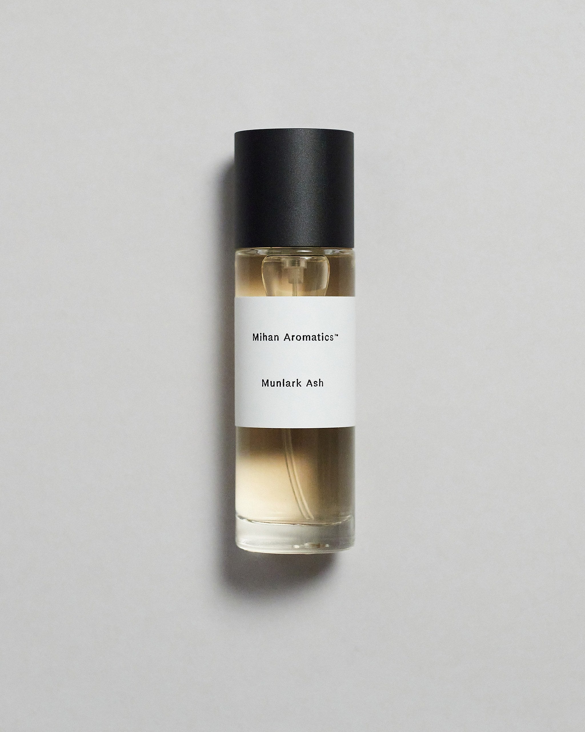 Mihan Aromatics Munlark Ash parfum 30ml bottle with black cap on a pale grey backdrop