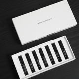 Mihan Aromatics Discovery Set open on dark timber, seven parfum vials beside the lid
