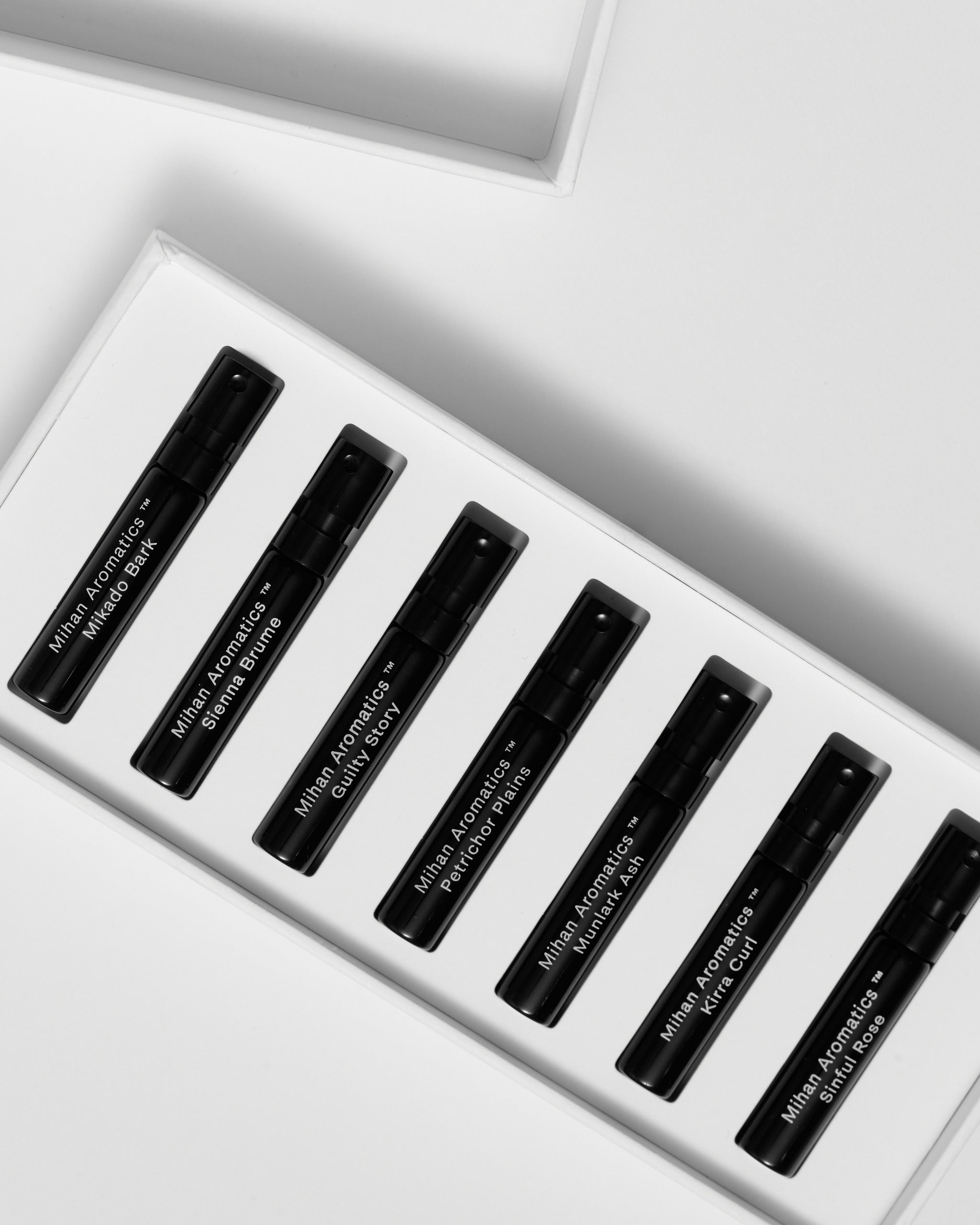 Close view of the seven labelled 2ml parfum vials inside the Mihan Aromatics Discovery Set