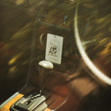 Mihan Aromatics Petrichor Plains Air Fragrance hanging in a vintage car interior above the gear stick