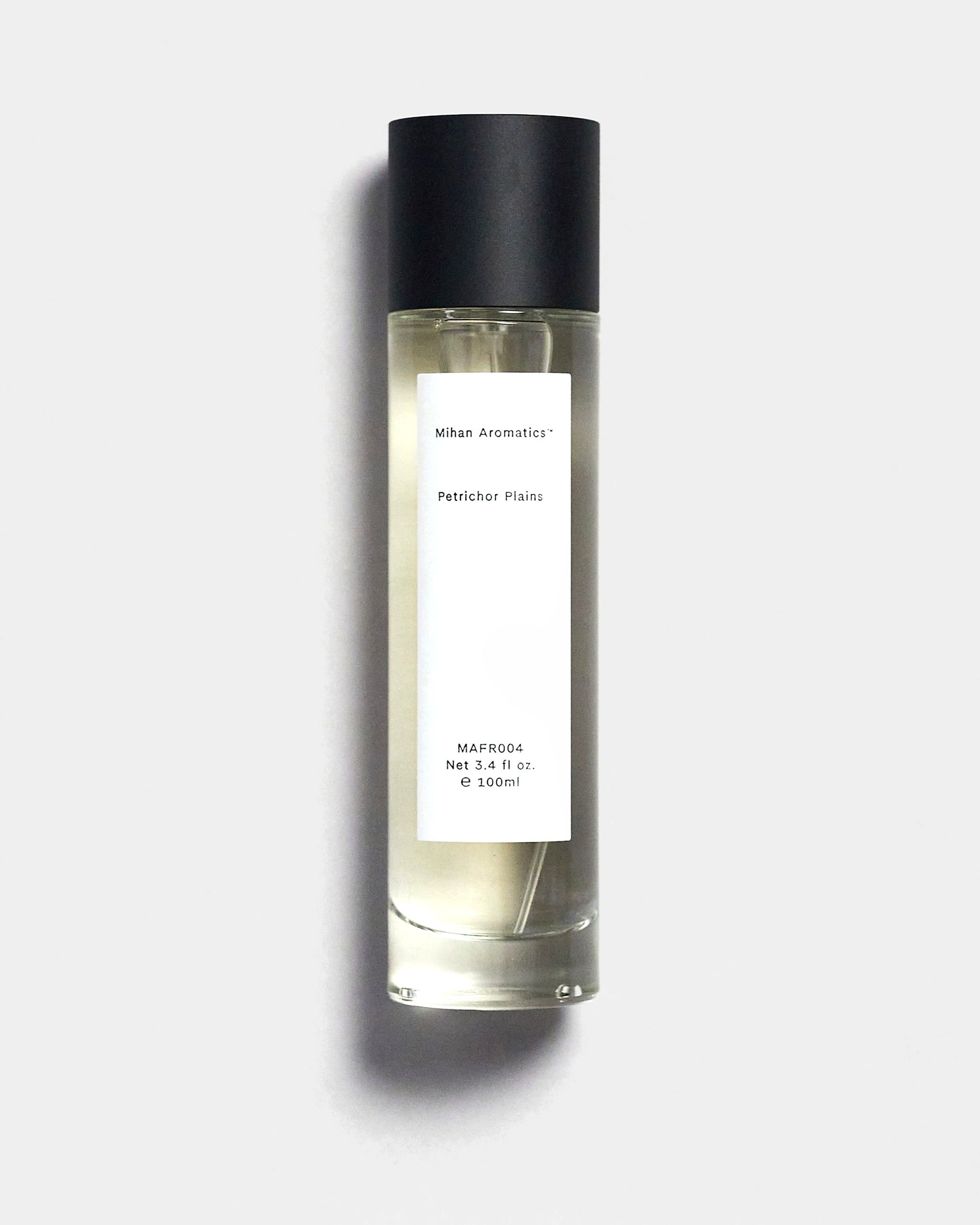 Mihan Aromatics Petrichor Plains parfum 100ml bottle with black cap on a Studio Grey backdrop