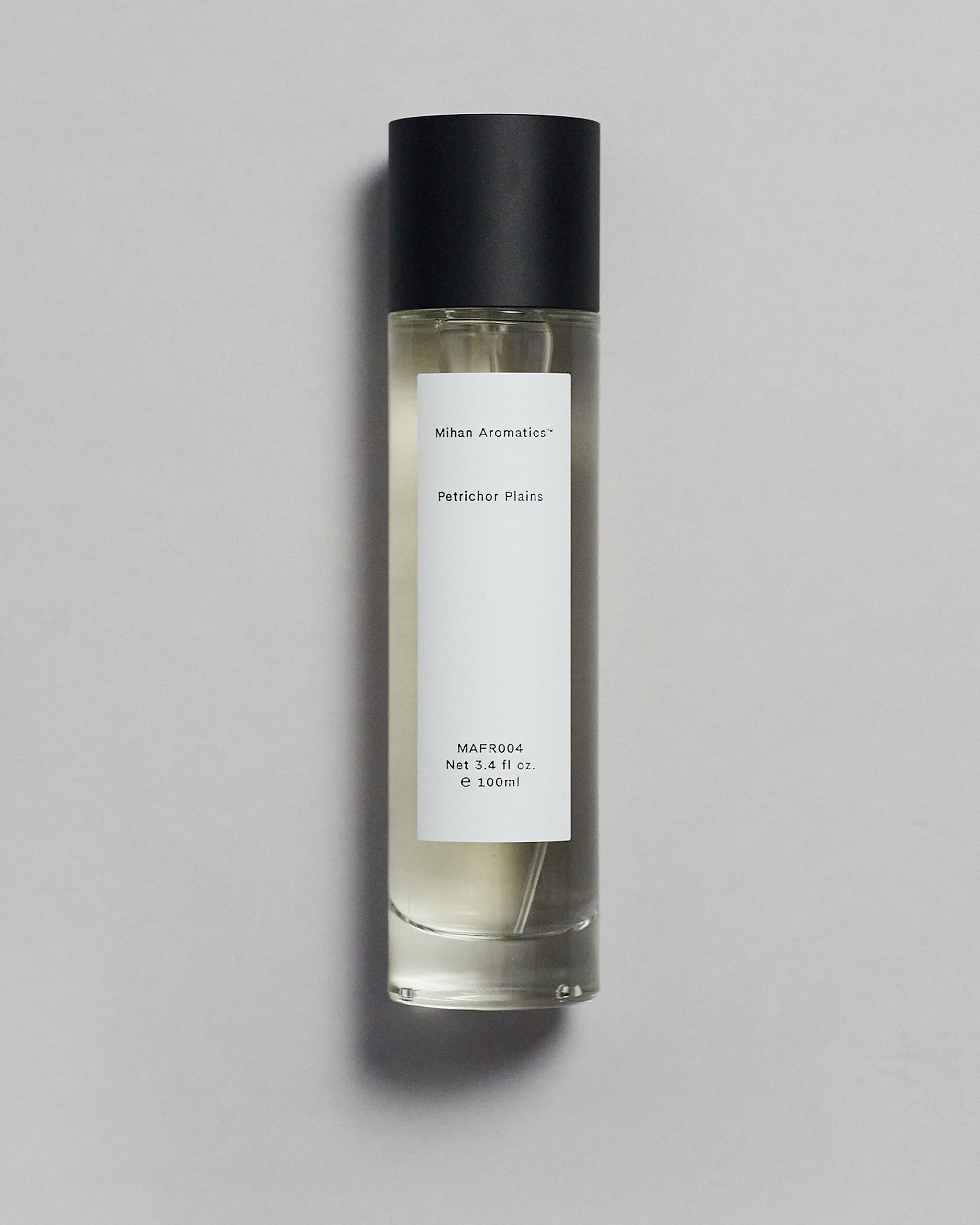 Mihan Aromatics Petrichor Plains parfum 100ml bottle with black cap on a pale grey backdrop