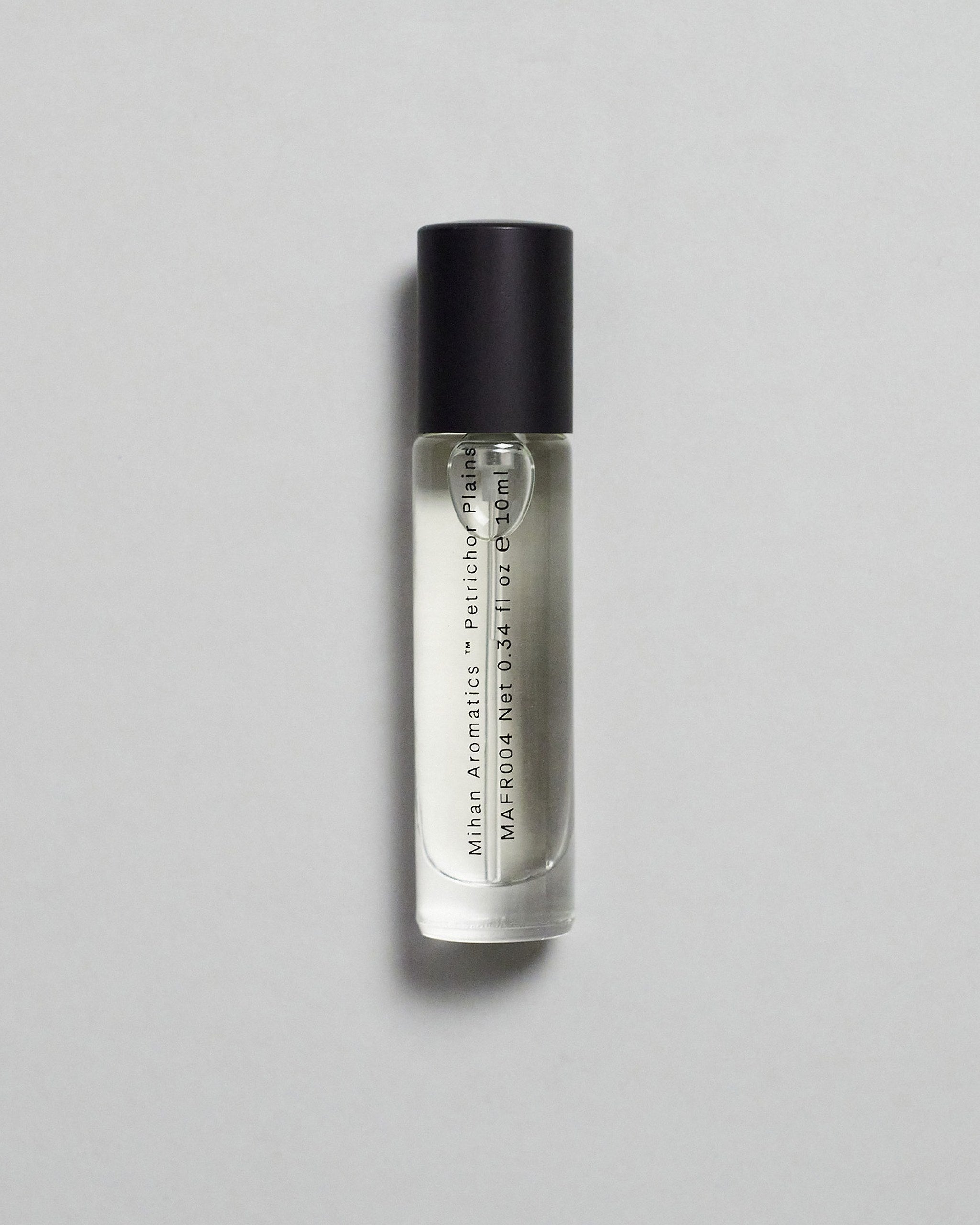 Mihan Aromatics Petrichor Plains parfum 10ml bottle with black cap on a pale grey backdrop