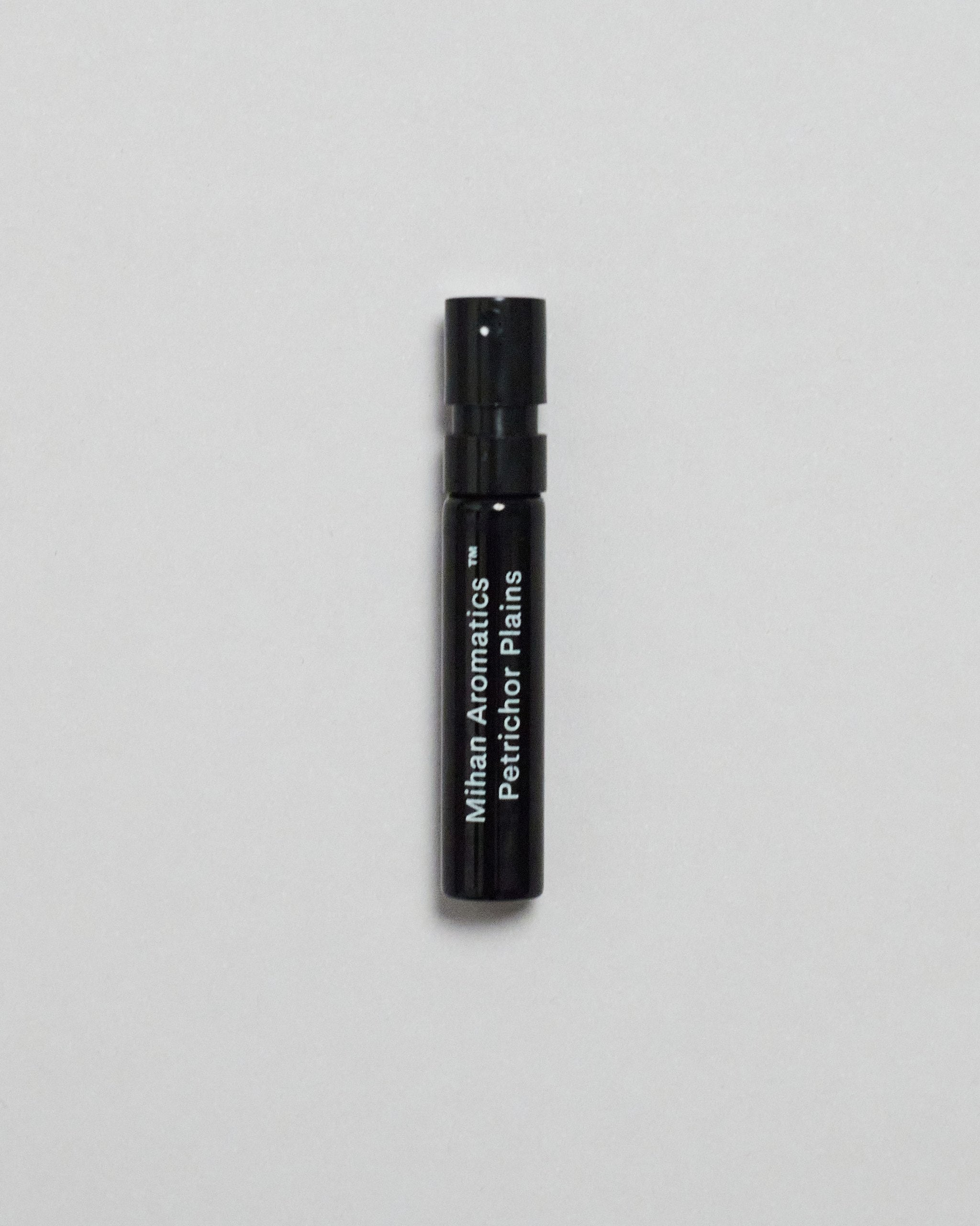 Mihan Aromatics Petrichor Plains parfum 2ml sample vial on a pale grey backdrop