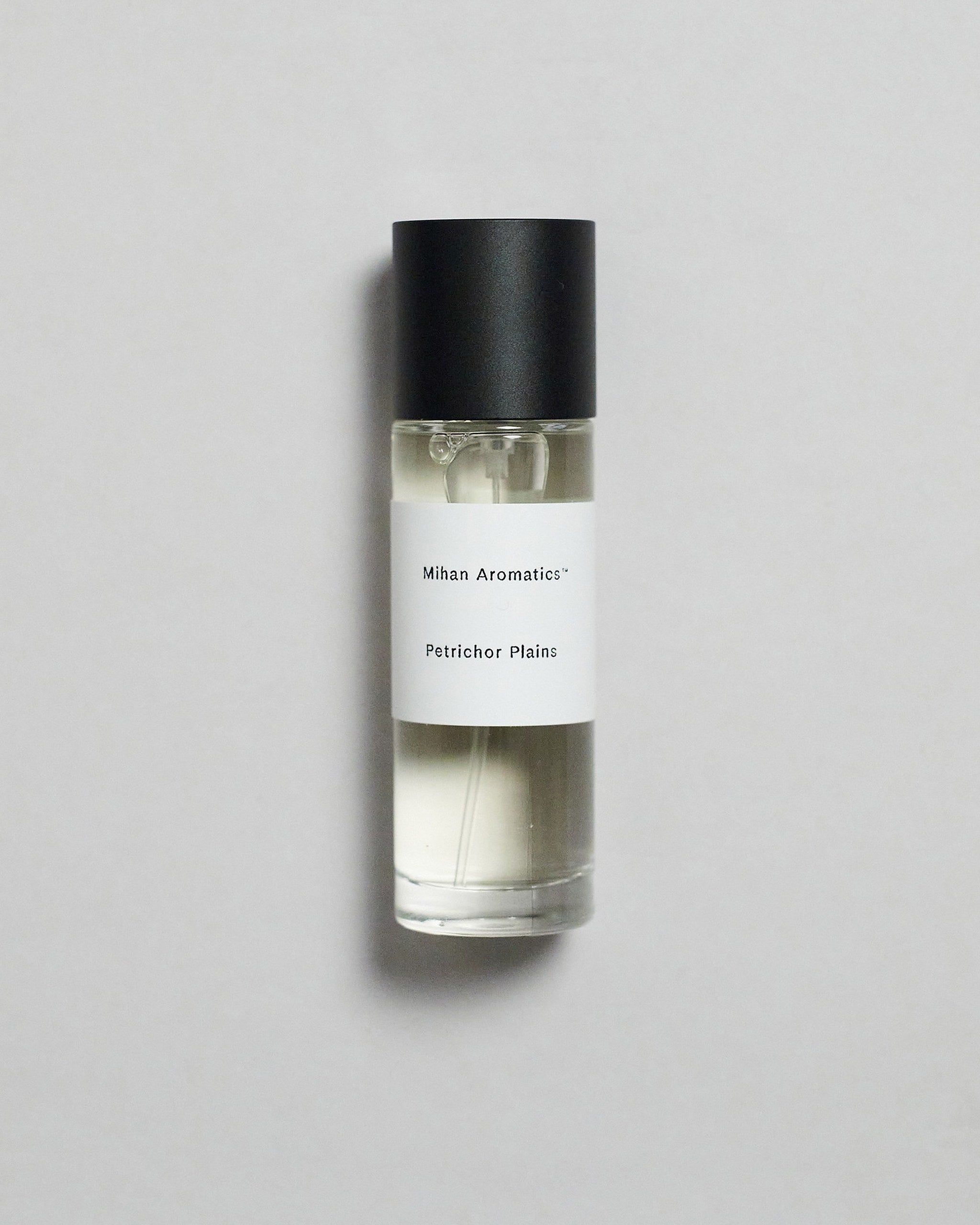 Mihan Aromatics Petrichor Plains parfum 30ml bottle with black cap on a pale grey backdrop