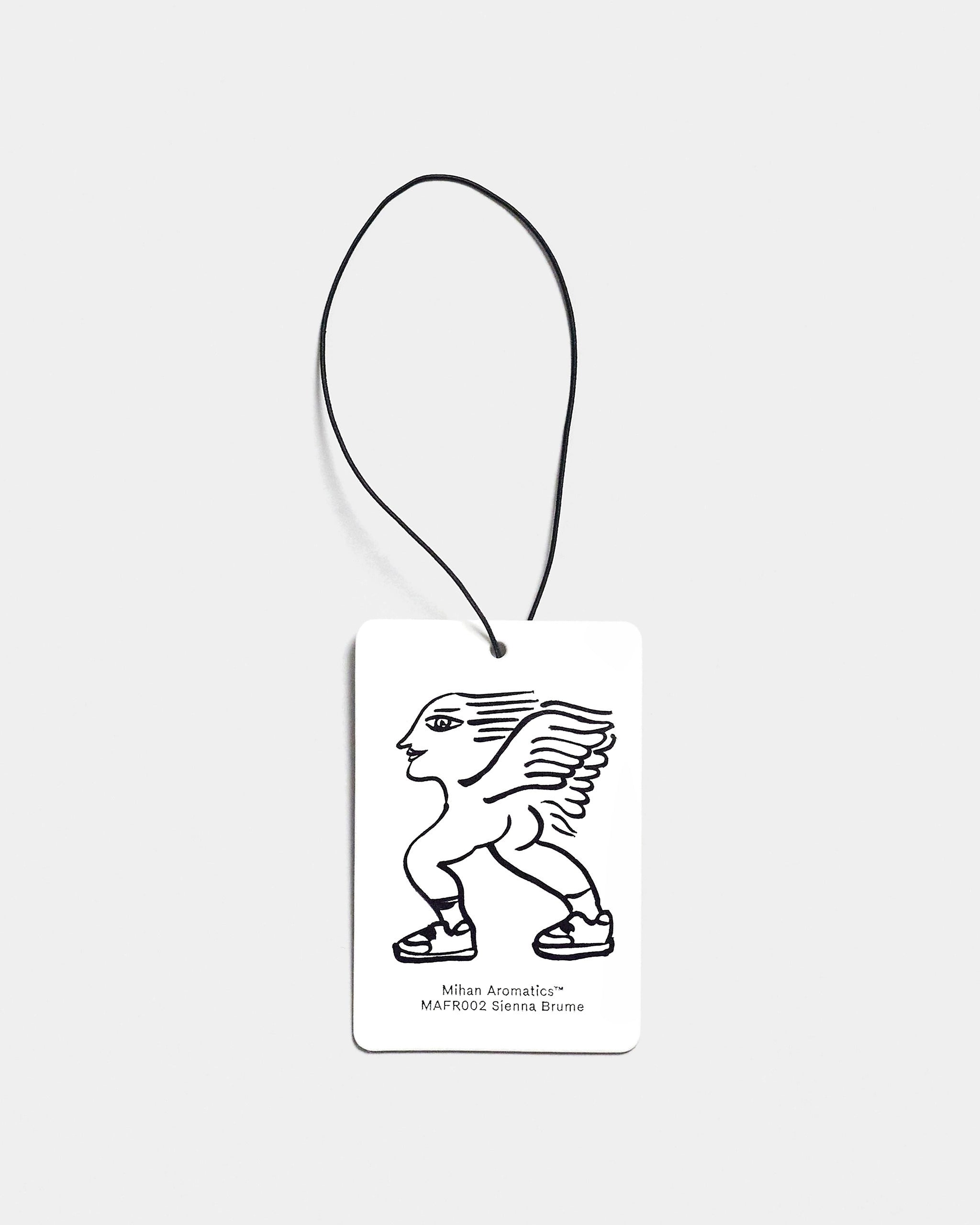 Mihan Aromatics Sienna Brume Air Fragrance card with illustrated design and black cord on a Studio Grey backdrop