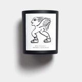 Mihan Aromatics Sienna Brume candle in a black vessel with illustrated label on a Studio Grey backdrop