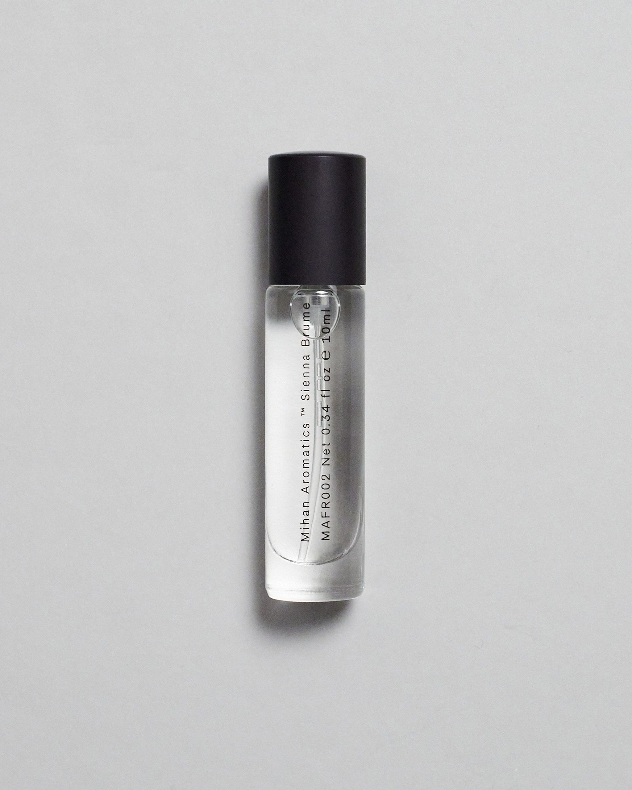 Mihan Aromatics Sienna Brume parfum 10ml bottle with black cap on a pale grey backdrop