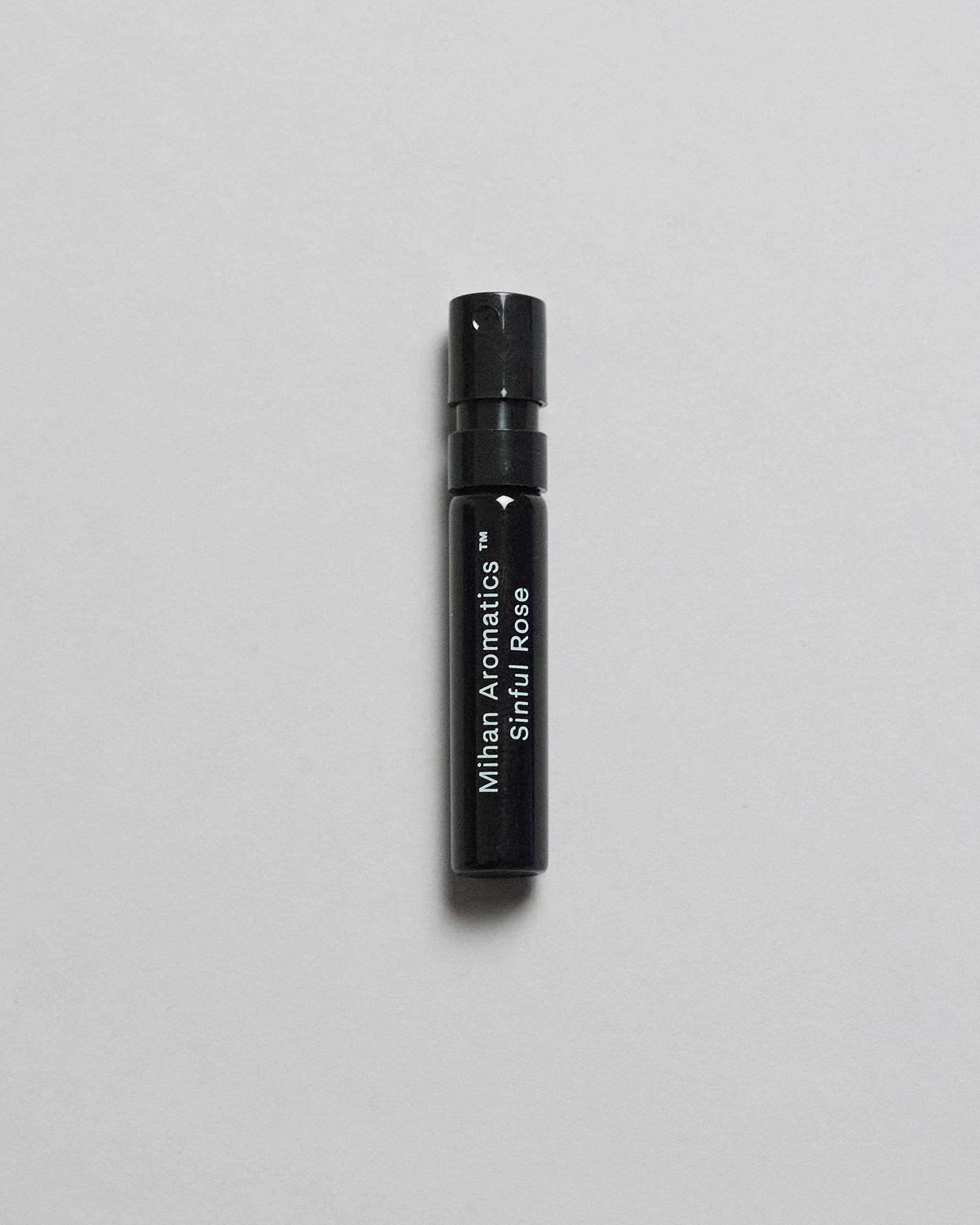 Mihan Aromatics Sinful Rose parfum 2ml sample vial on a pale grey backdrop