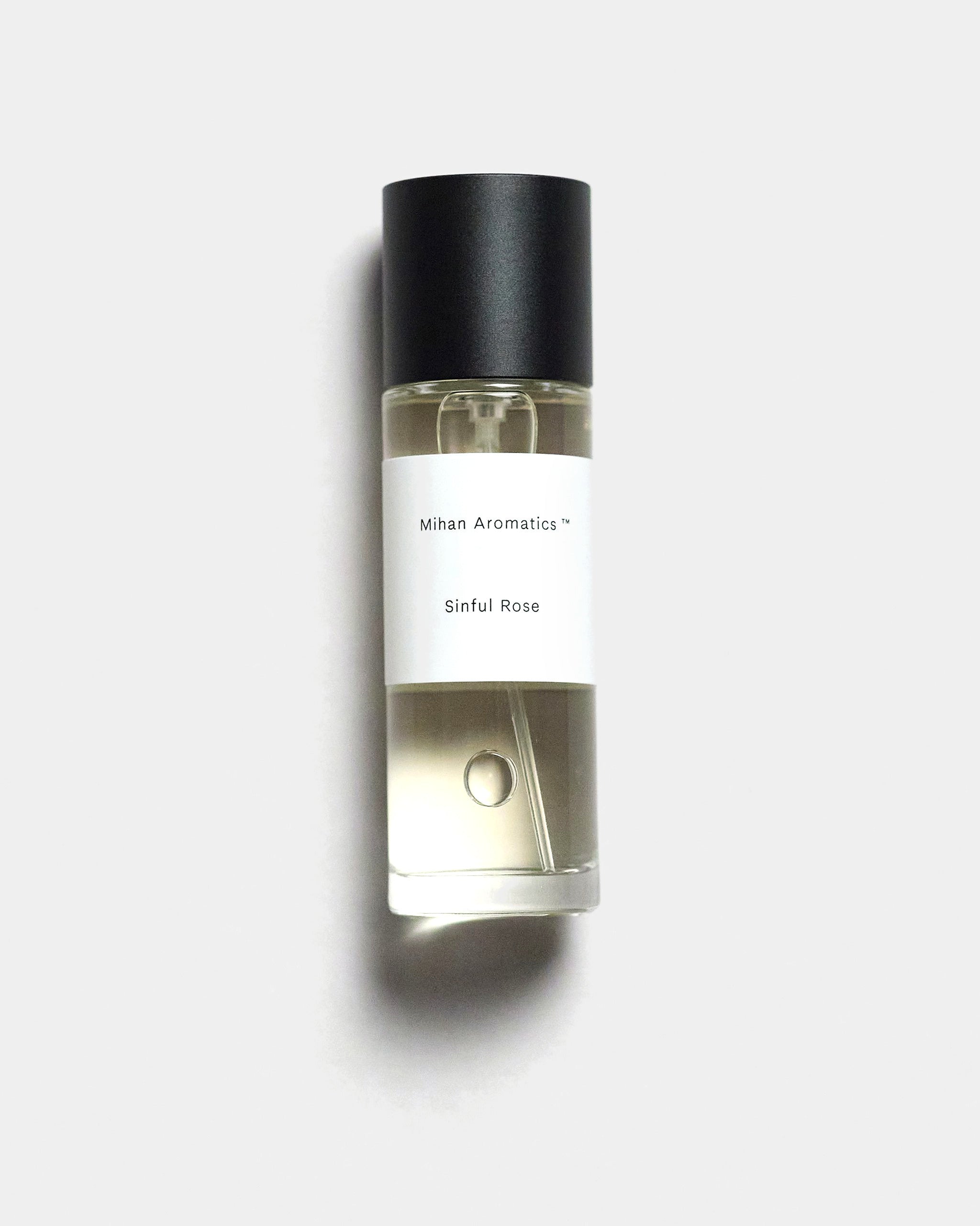 Mihan Aromatics Sinful Rose parfum 30ml bottle with black cap on a Studio Grey backdrop