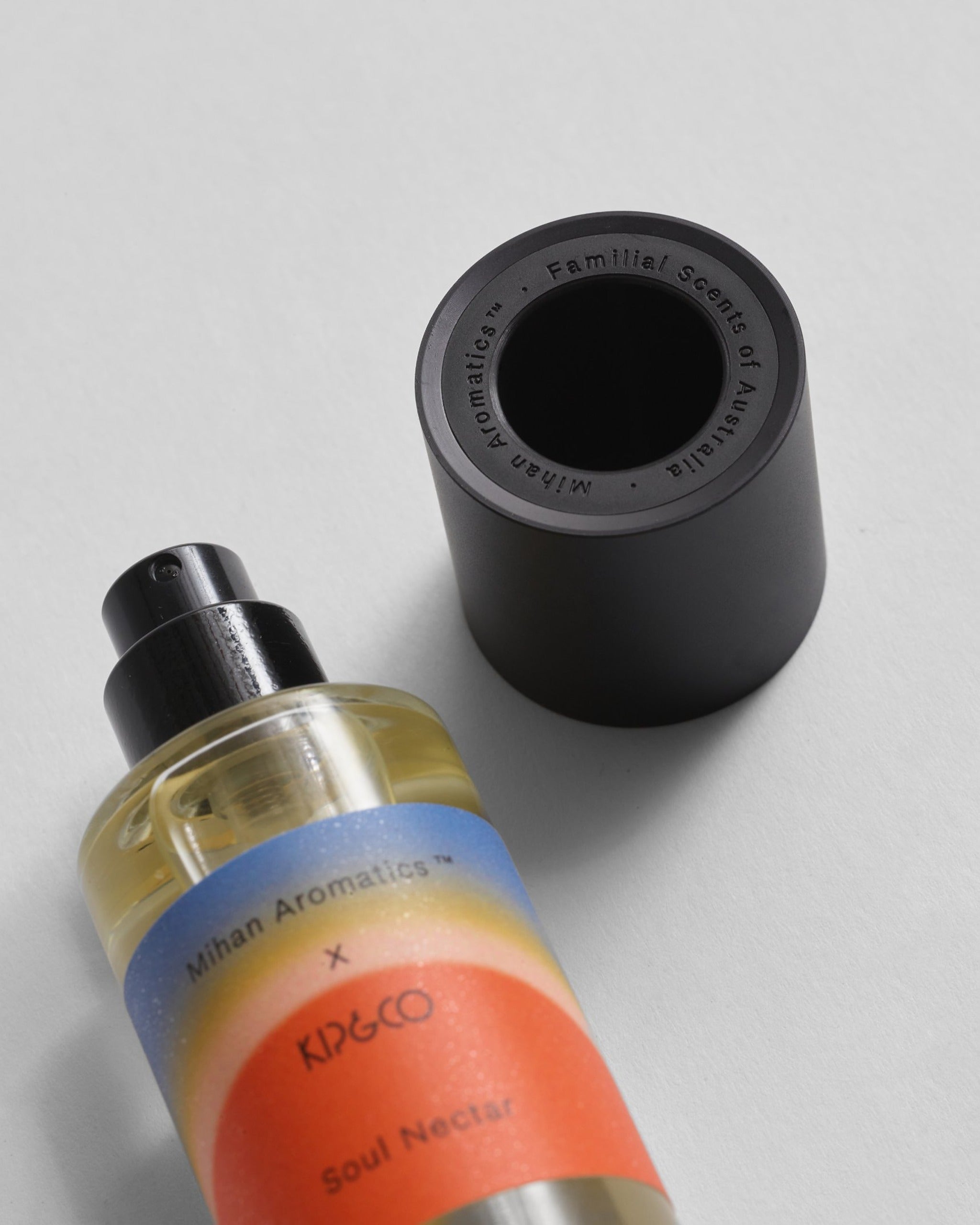 Soul Nectar parfum bottle beside its black cap engraved with Mihan Aromatics, Familial Scents of Australia