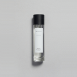 Mikado Bark Parfum bottle on a gray background, evoking autumn's calm with crisp air and soft sunlight.