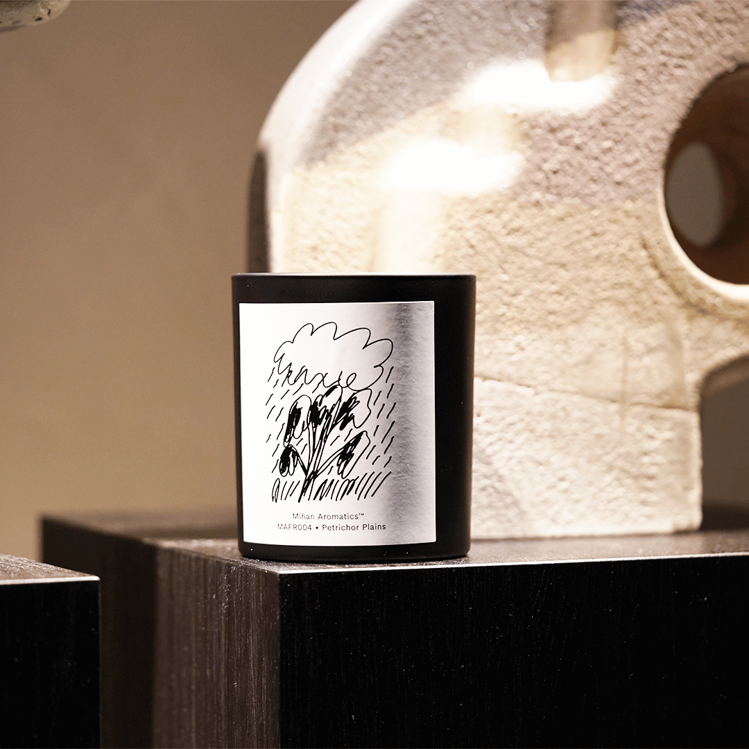 Petrichor Plains Candle by Mihan Aromatics displayed on a shelf, showcasing its stylish design and unique packaging.