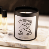 Sienna Brume Candle in black vessel with whimsical design, showcasing luxury hand-poured soy wax for a long-lasting burn.