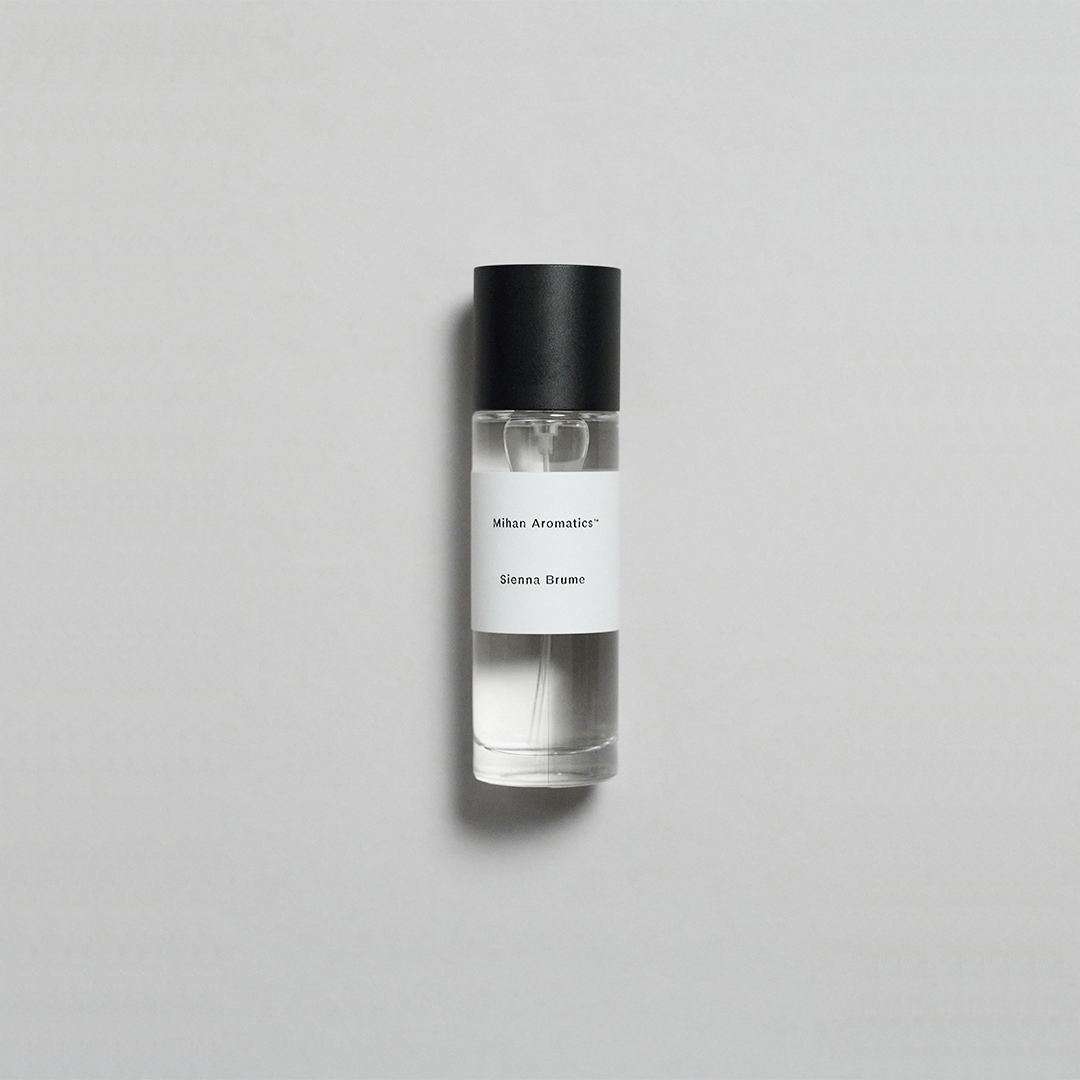 Sienna Brume Parfum bottle on a light background, evoking summer vibes with coconut and cucumber notes.