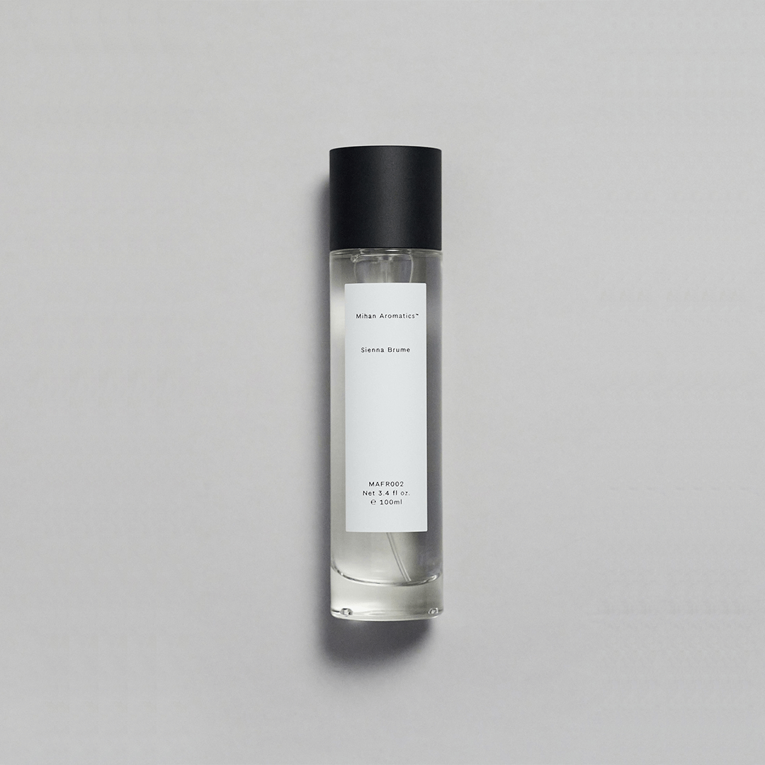 Sienna Brume Parfum bottle featuring a minimalist design with a black cap and crisp fragrance.