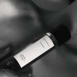 Bottle of Sinful Rose Parfum by Mihan Aromatics held close, showcasing an elegant design and intimate essence.