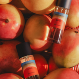 Two Soul Nectar Parfum bottles by Mihan Aromatics x Kip&Co displayed among ripe apples.